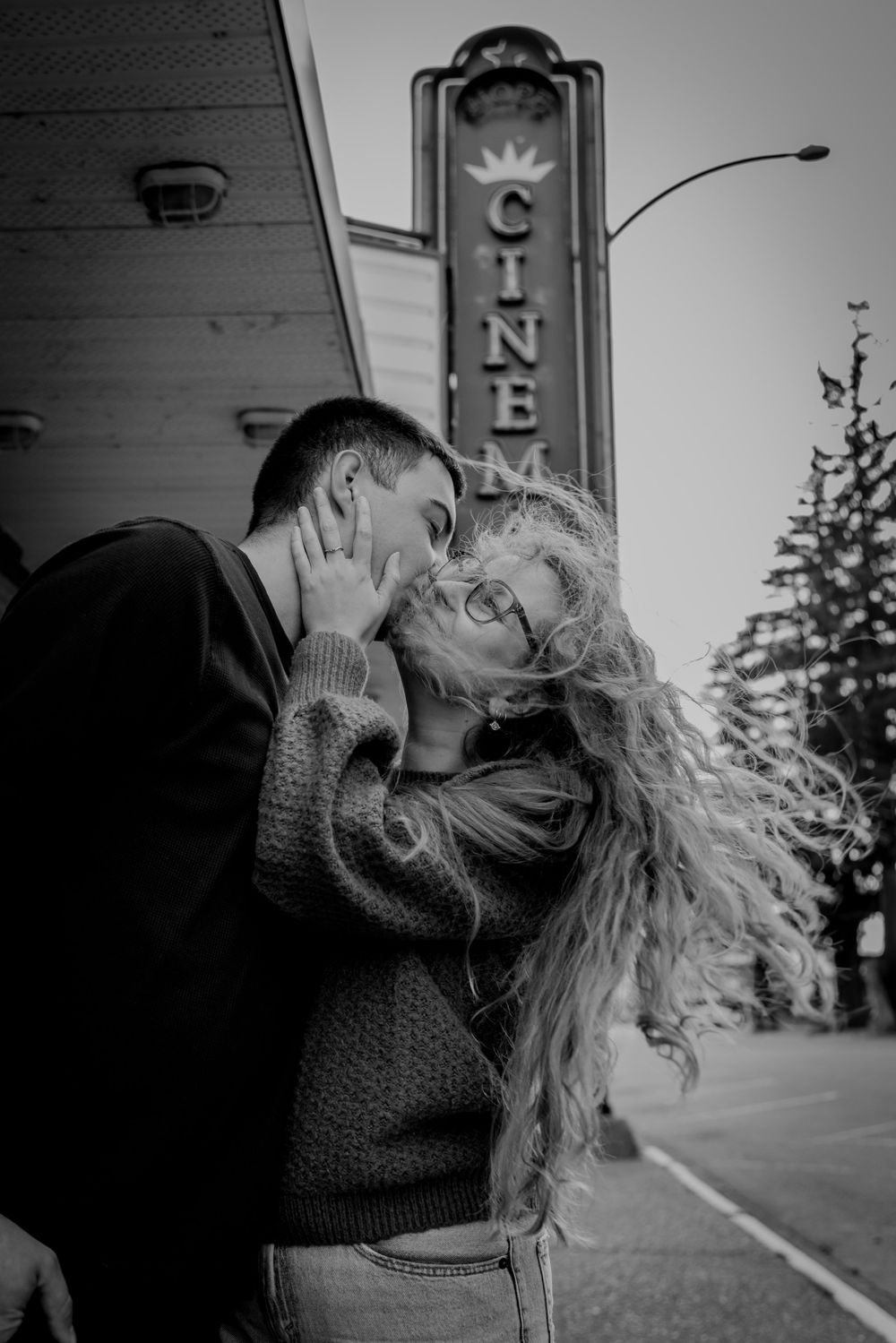Black and white photo series showing intimate moments between two people in an outdoor setting.
