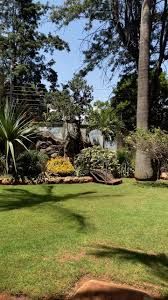 luxury garden wedding venue in Nairobi, captured by Nairobi Wedding Photographer, Bonnie Gichuru, showcasing lush greenery and flower arches