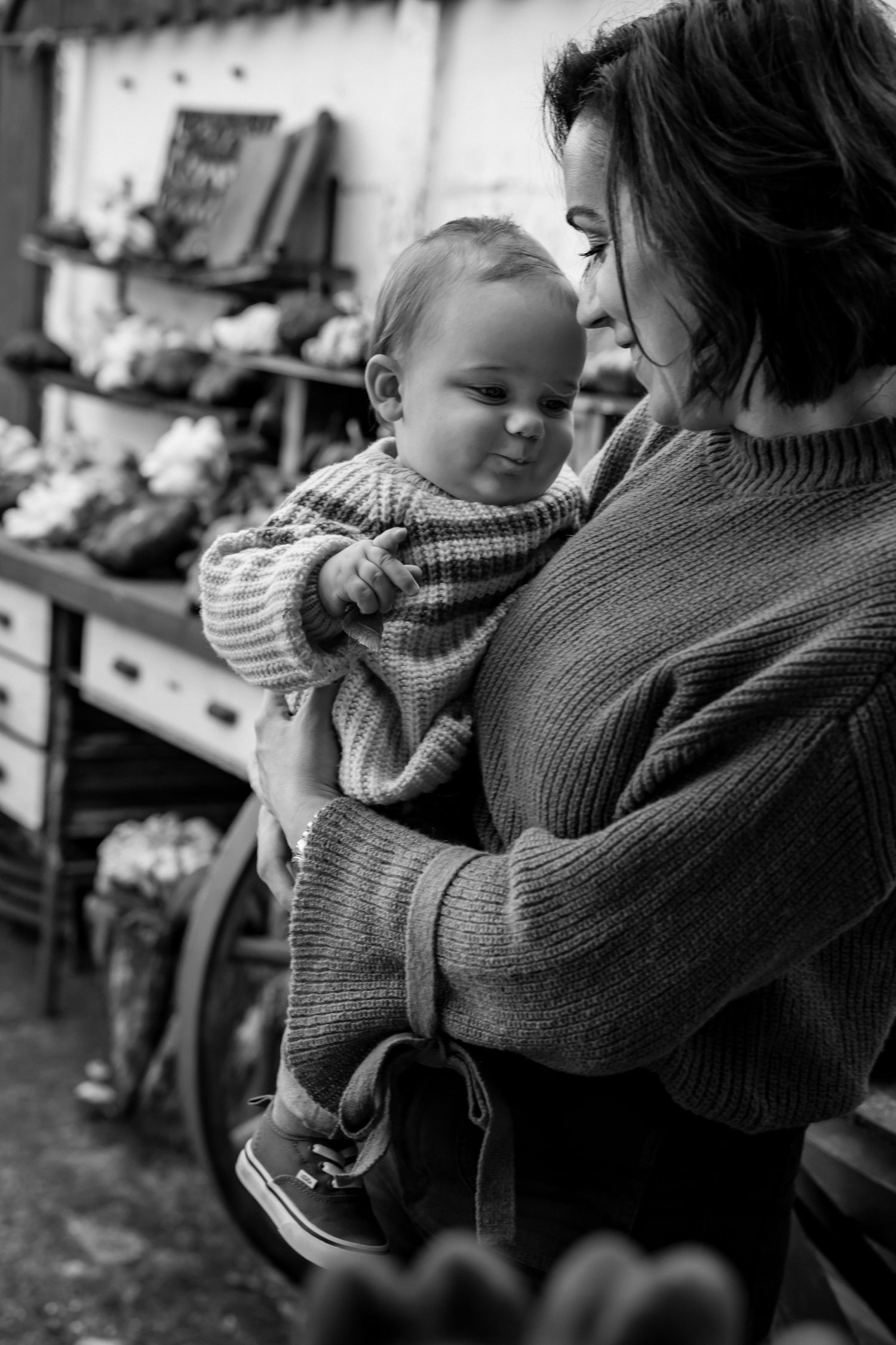 Intimate black and white photo of tender moment in cozy sweaters.