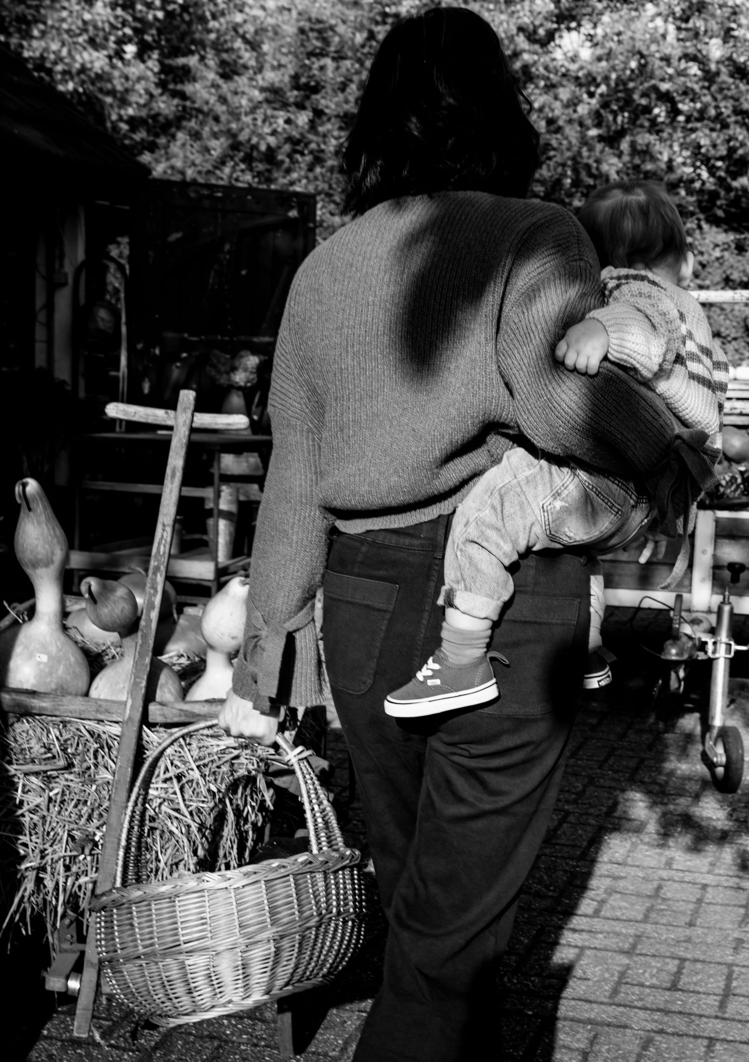 Series of black and white images showing autumn activities with pumpkins and baskets.
