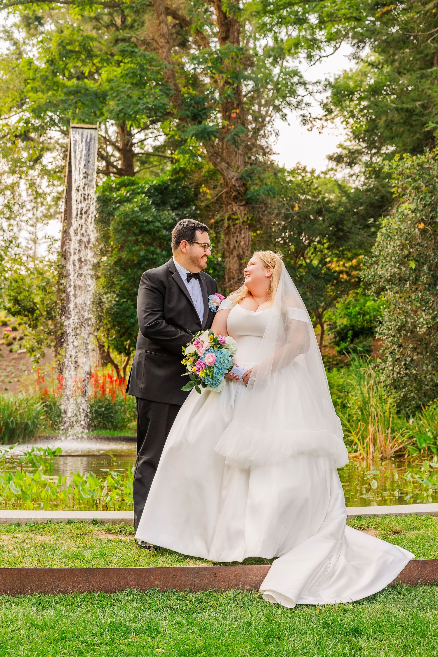 A romantic wedding couple shares intimate moments in a lush garden setting during golden hour.