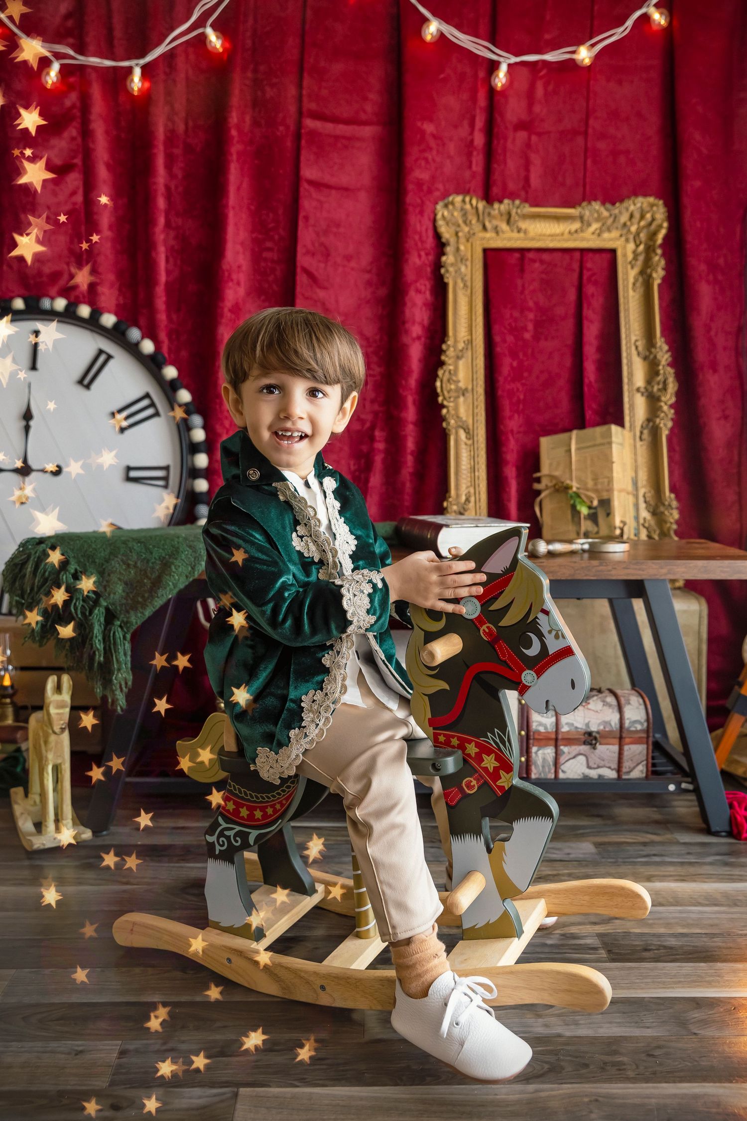 3 year old boy riding a wooden horse child photographer