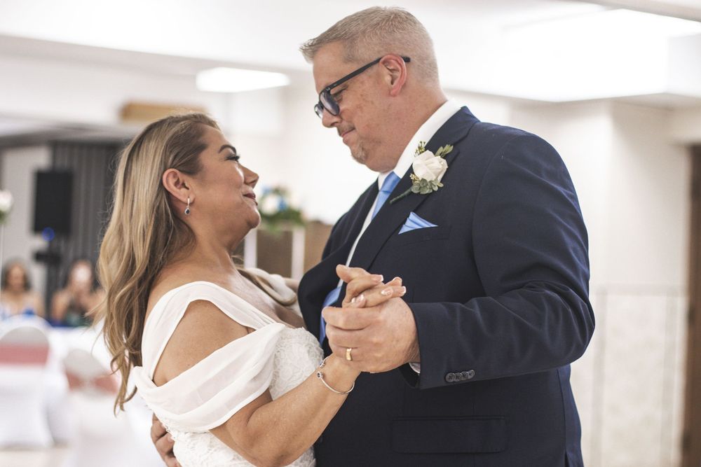 Bride and groom sharing romantic first dance at wedding reception.