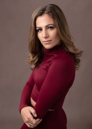 A woman in a burgundy turtleneck sweater poses against a neutral backdrop in a series of elegant portrait shots.
