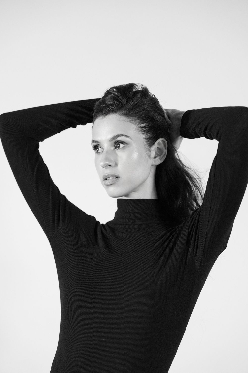 Black and white artistic portrait series showing dramatic poses against white background in minimalist style.