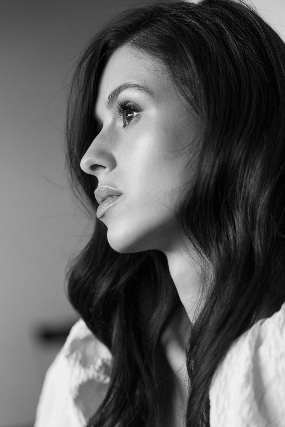 A series of black and white profile portraits showing dark hair and dramatic lighting in an artistic composition.