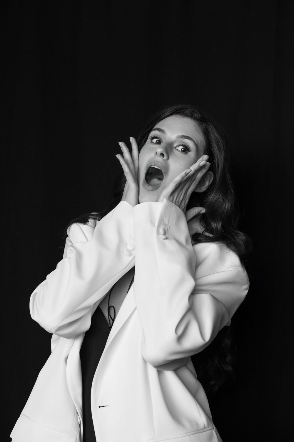 A dramatic black and white photo sequence shows a person in a white shirt expressing different emotional reactions.