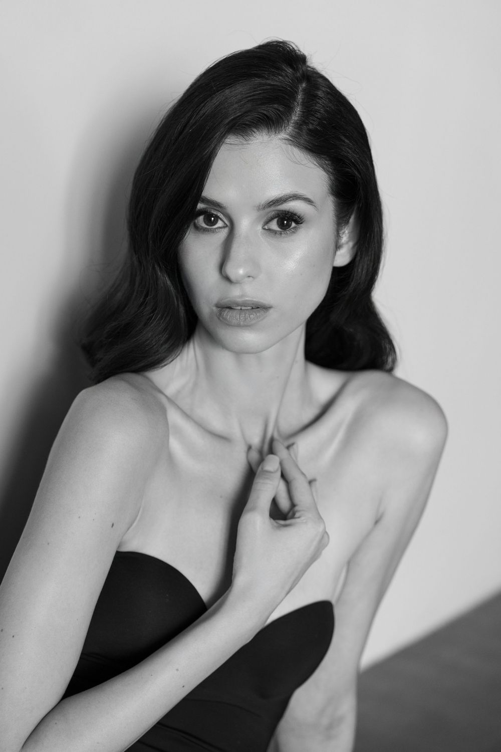 Black and white portrait series showing dramatic poses and expressions against a white background.