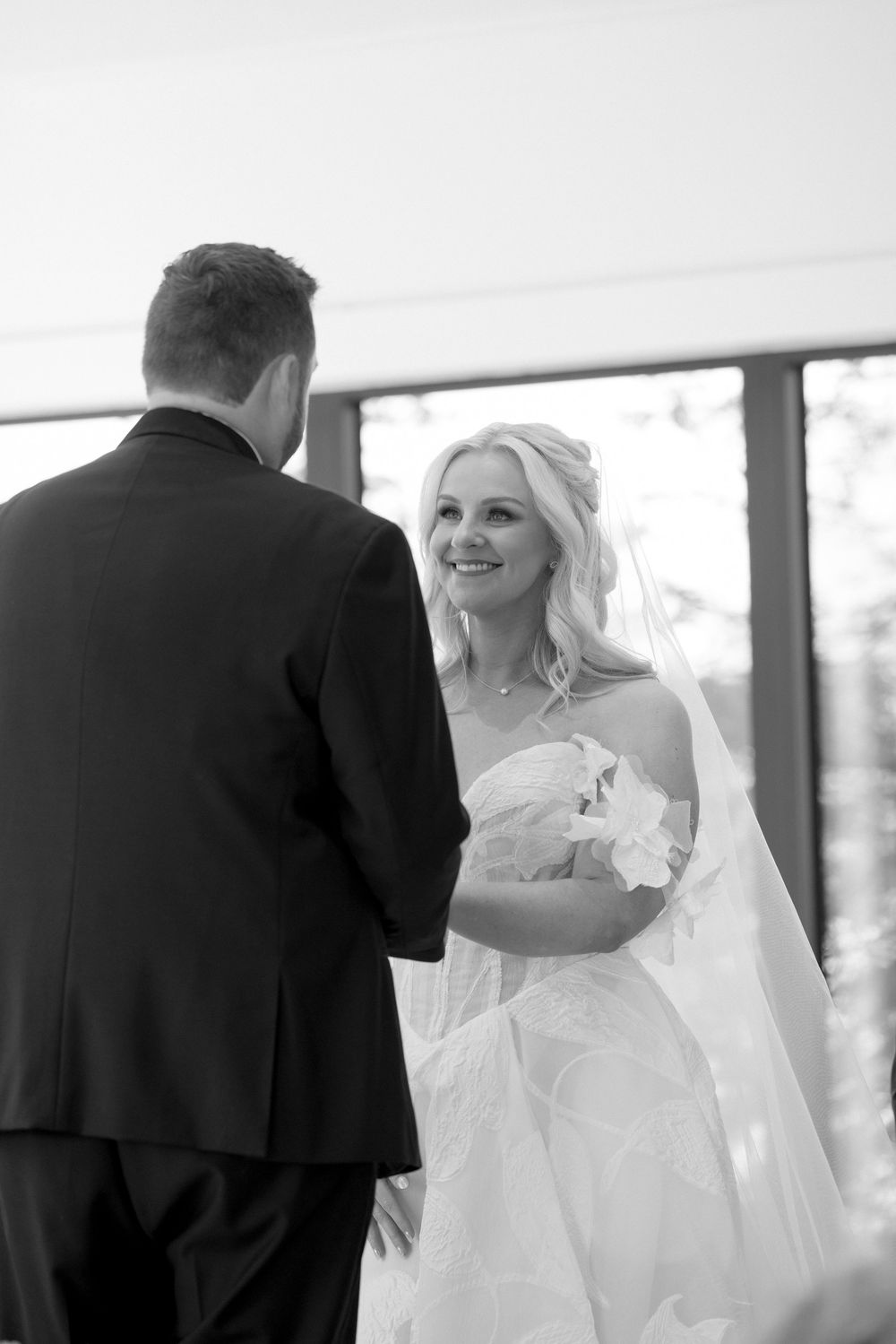 Black and white series capturing intimate first look moments between a bride and groom.
