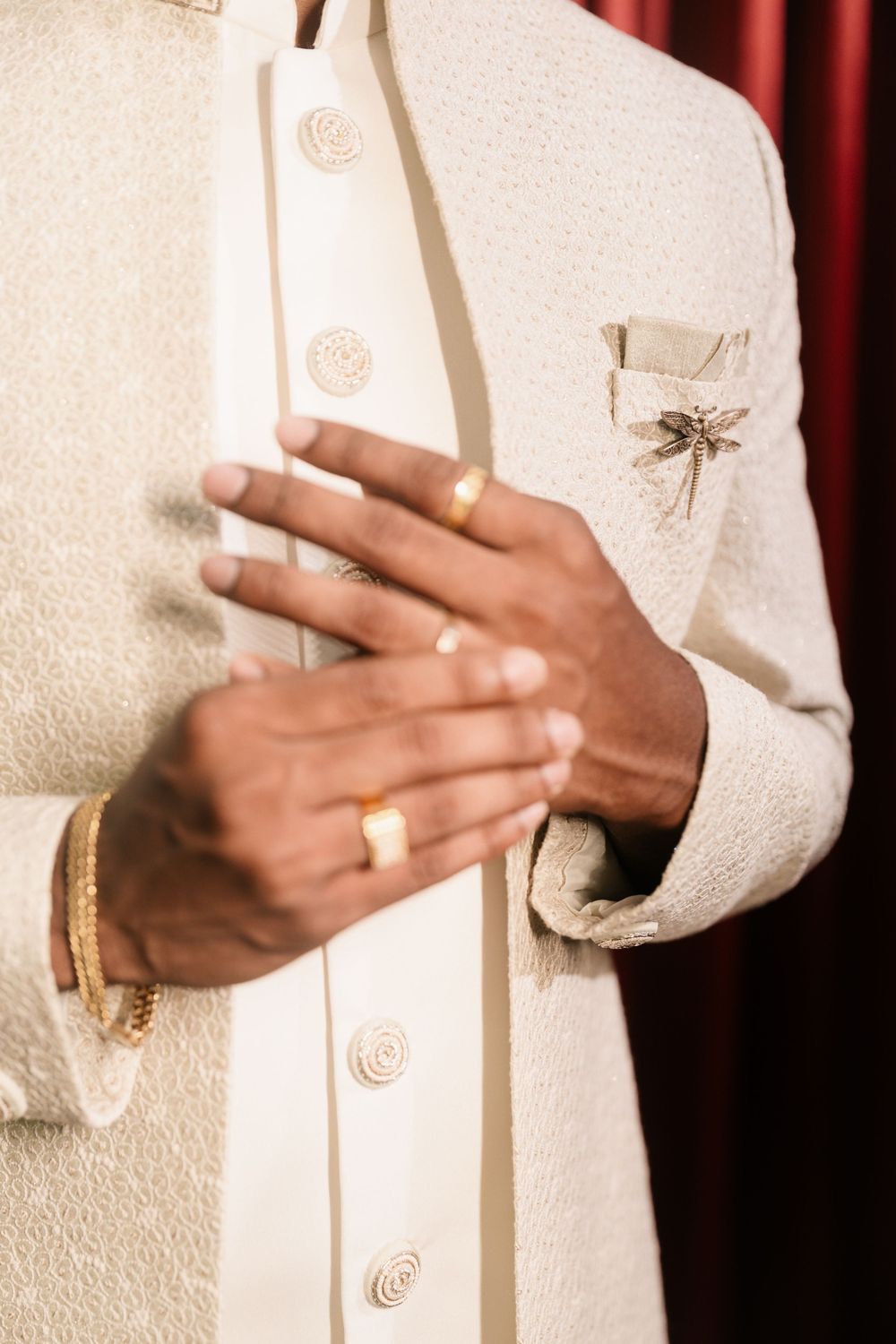 Close-up sequence of hands wearing white sleeves making expressive gestures against a light background.