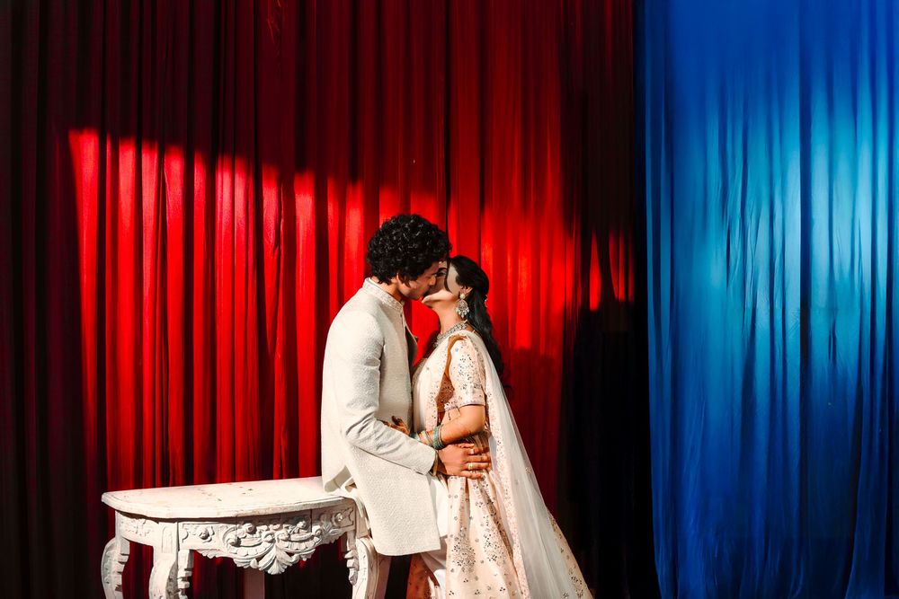 A stage curtain backdrop in vibrant red and blue colors with dramatic theatrical lighting effects.