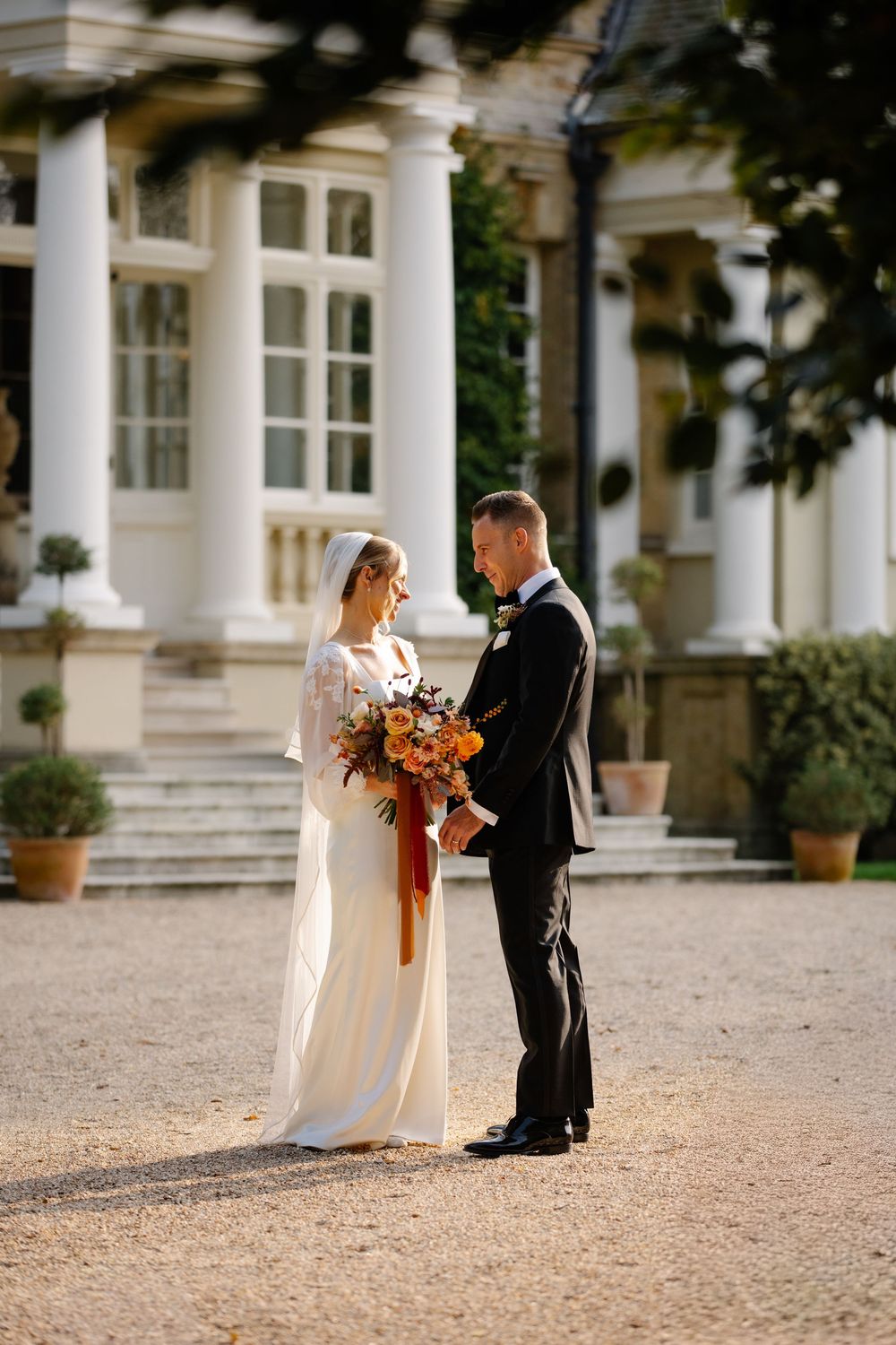 Bride and groom standing during golden hour couple portraits at a Hampshire wedding Pylewell park