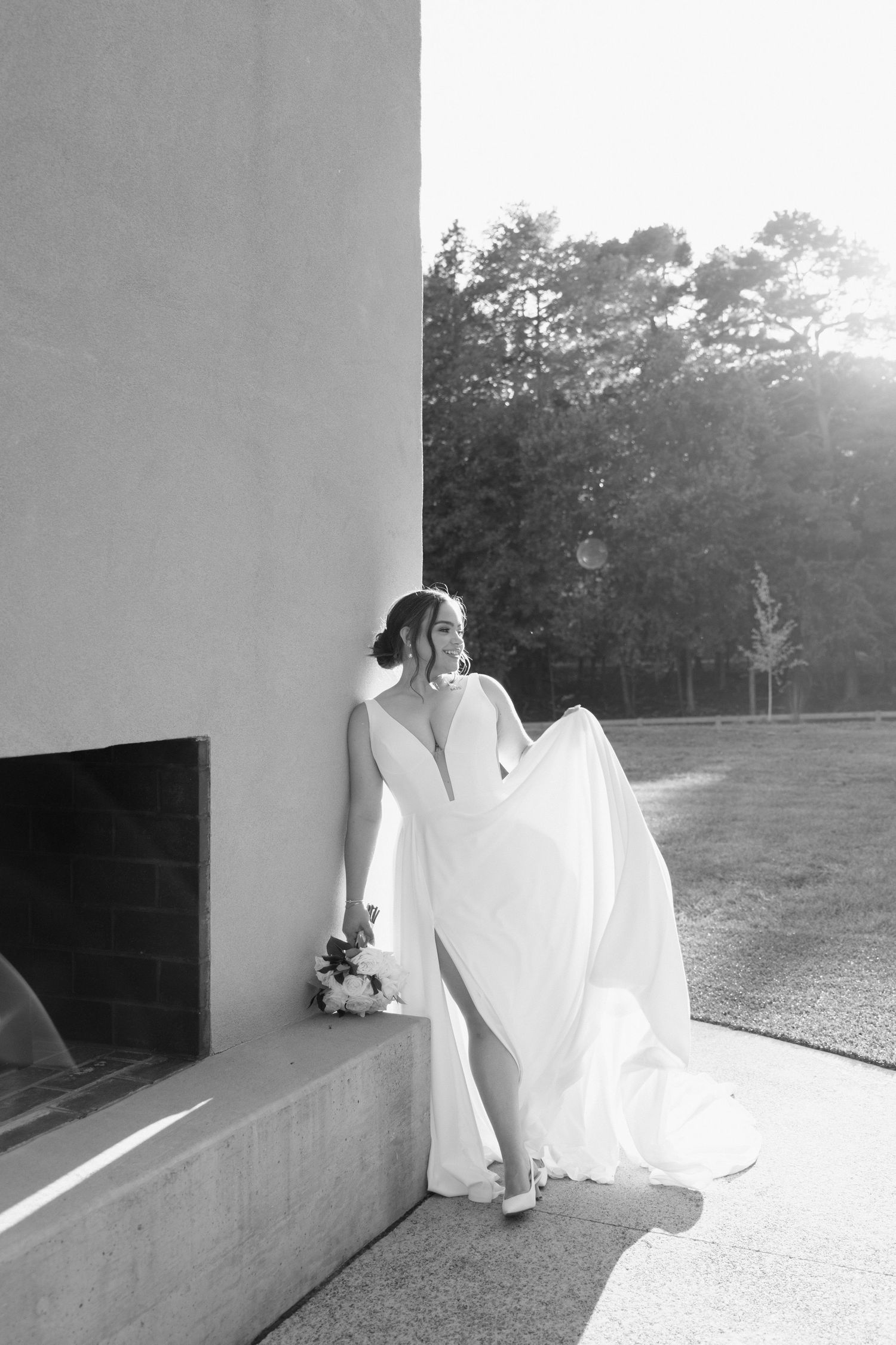 A series of minimalist black and white photos showing a figure in flowing white fabric against architectural walls.