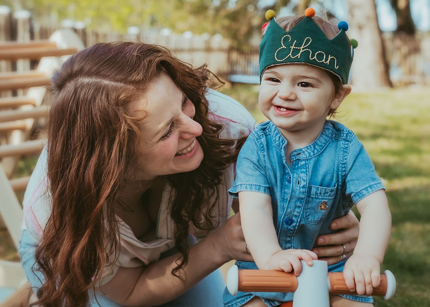 Family enjoys playful outdoor moments together on a sunny day in a park setting.