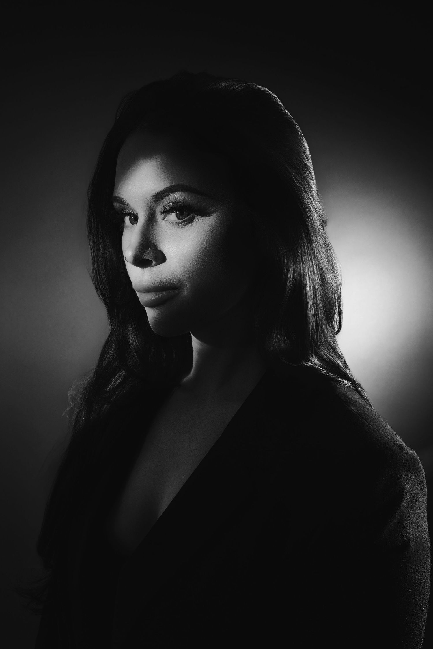 A dramatic black and white portrait series showing silhouetted profiles against moody lighting.