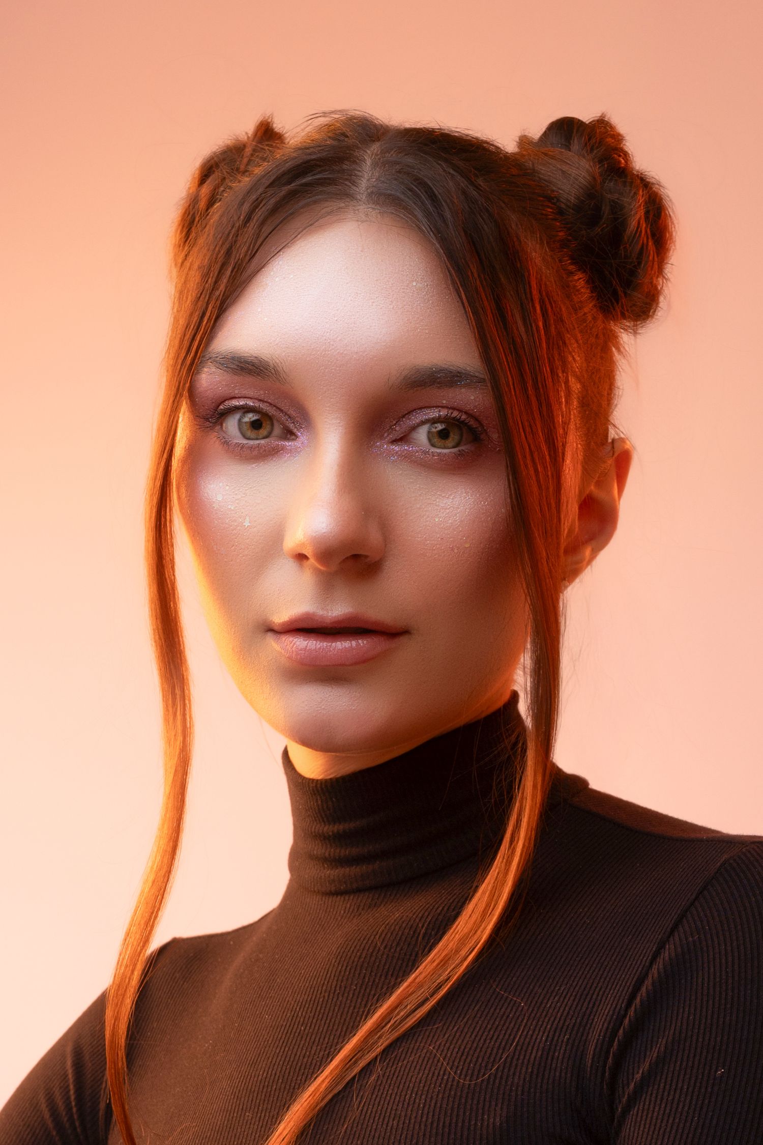 A series of five close-up portraits in warm lighting showing someone wearing a black turtleneck sweater.