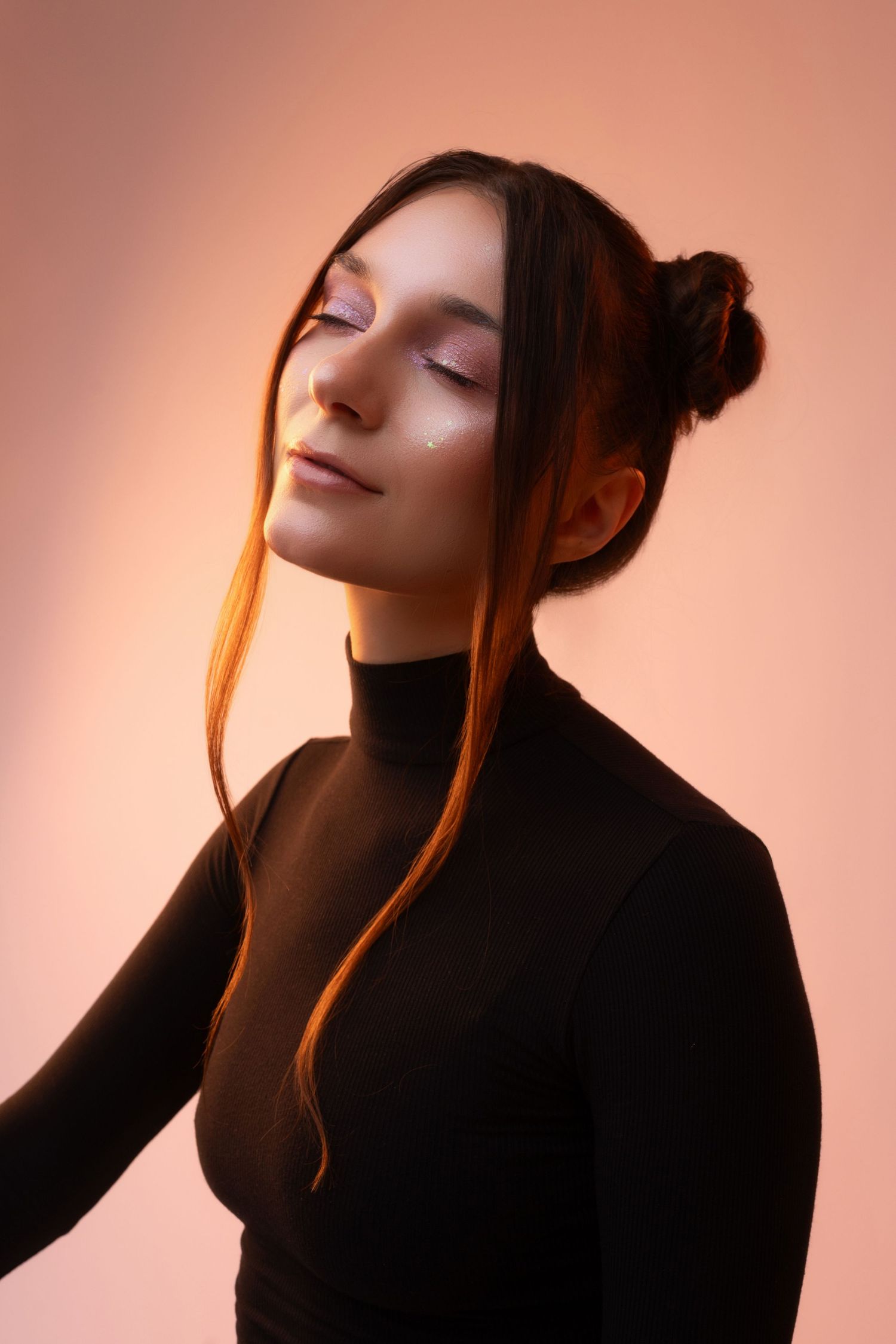Artistic portrait series in warm lighting showing graceful poses against a pink background.