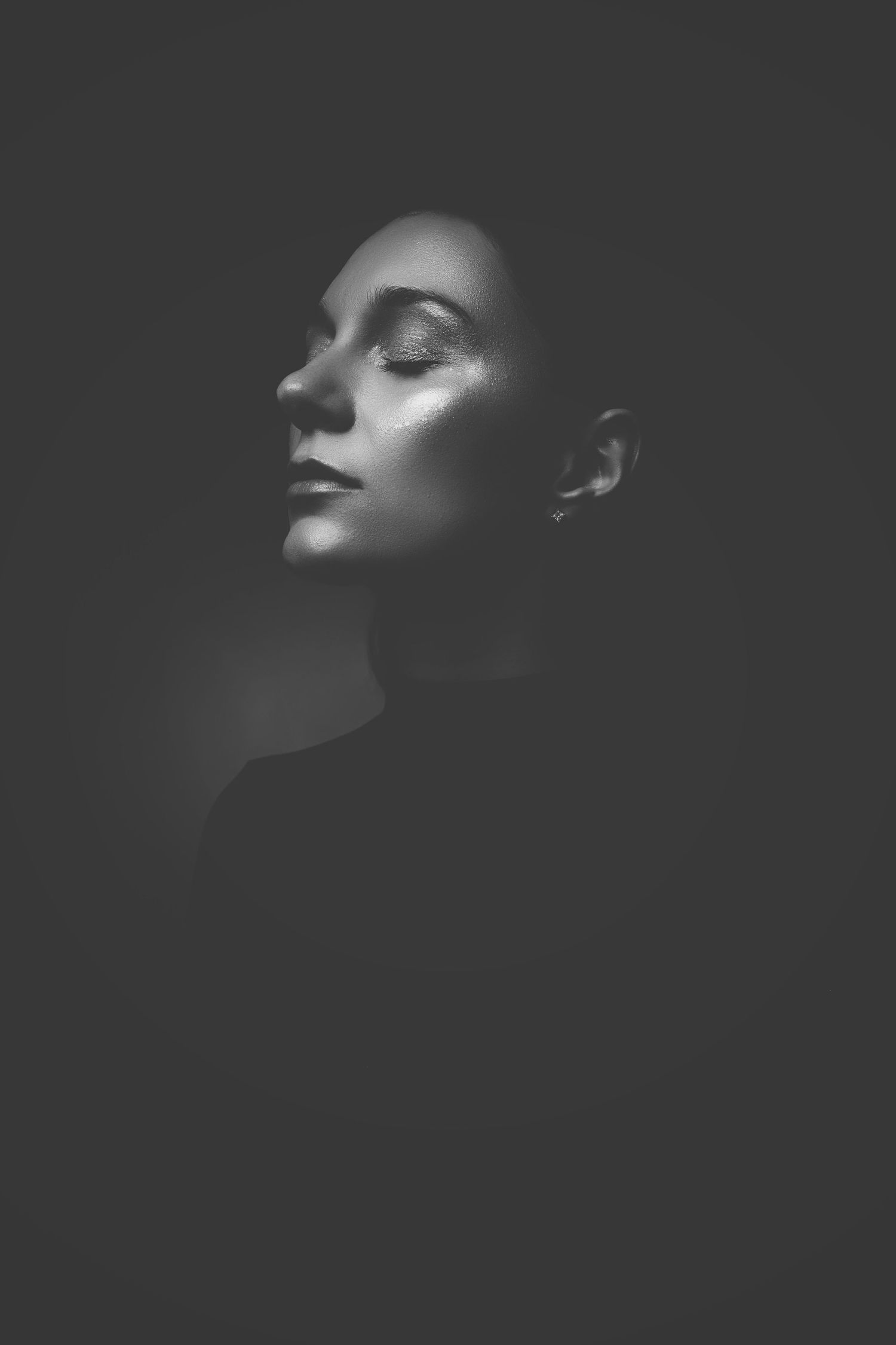 Dramatic black and white portrait sequence featuring profile silhouettes with strong contrast.
