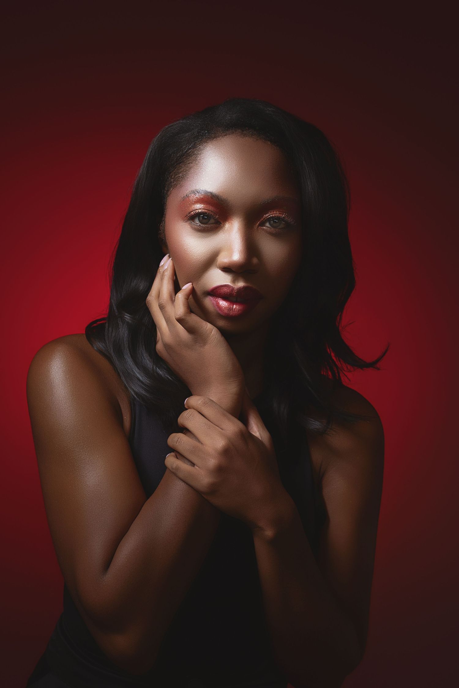 Artistic portrait series showing dramatic lighting and poses against a deep red background.