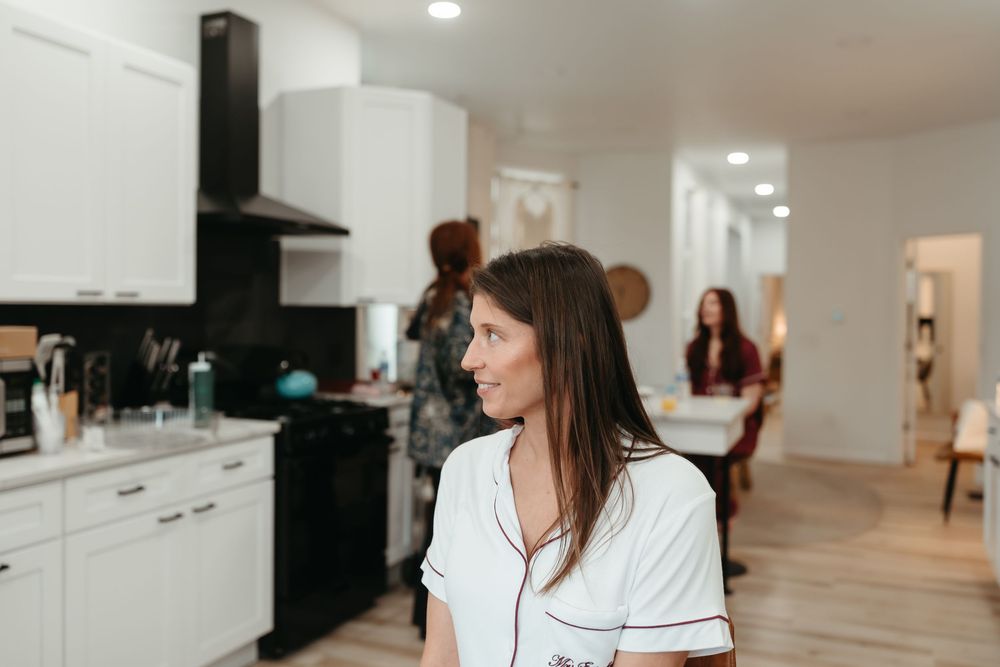 Modern white kitchen with stainless steel appliances and sleek cabinetry showcases clean lines and minimalist design.