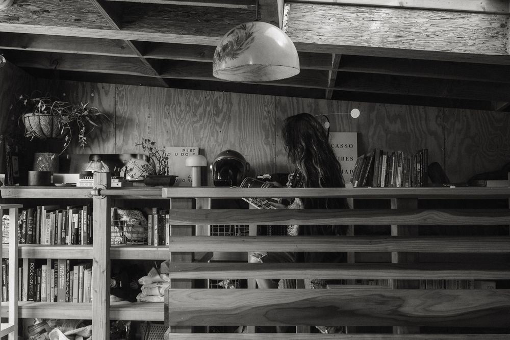 Black and white silhouette of a creative professional walking through her workspace.