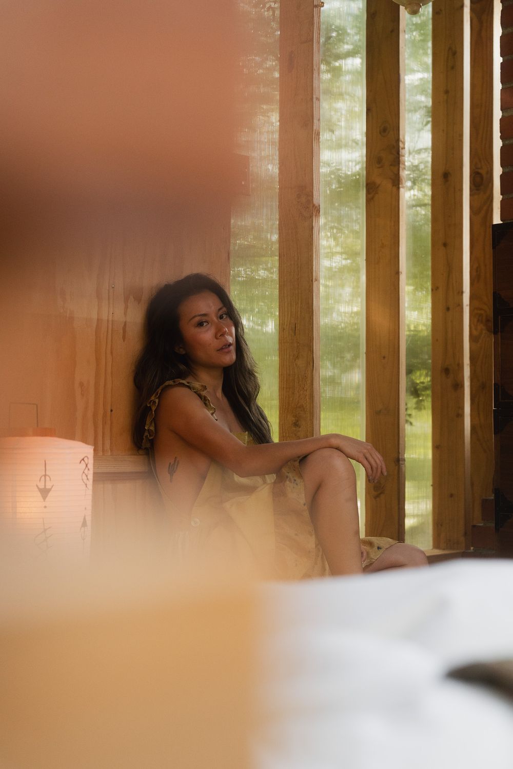 Lifestyle portrait of a creative reading in a warm and natural home setting.