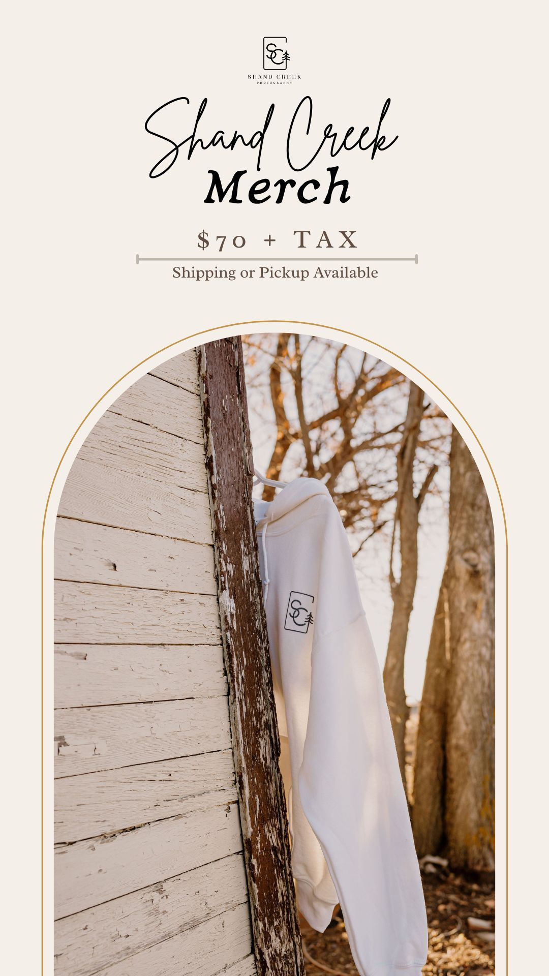 White merchandise sweatshirt hanging on rustic wooden wall with Shand Creek branding and $70 price tag displayed.