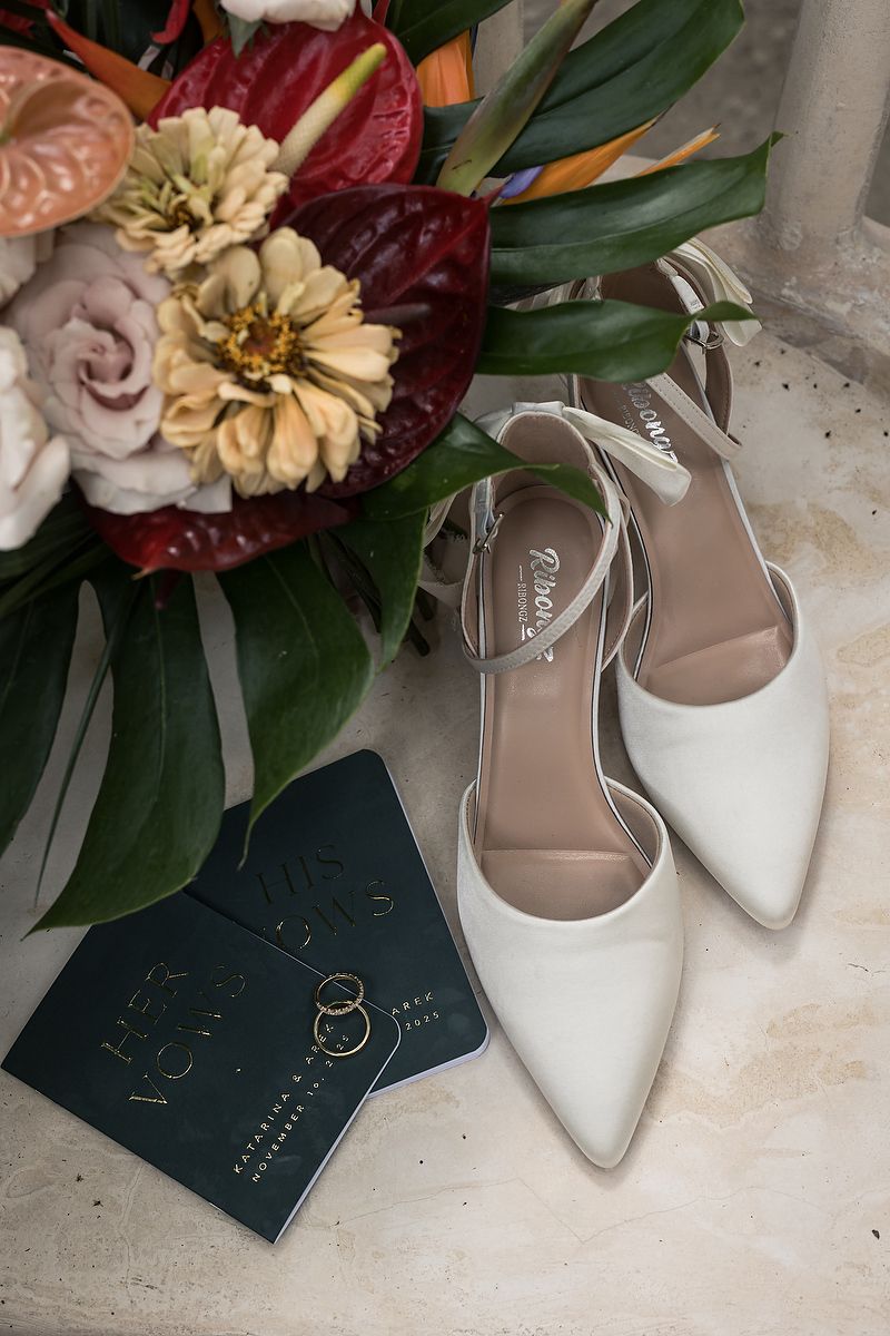 Bridal shoes and tropical bouquet flatlay at Mahayana Tulum, showcasing colorful floral design for a luxury beach wedding in Tulum.