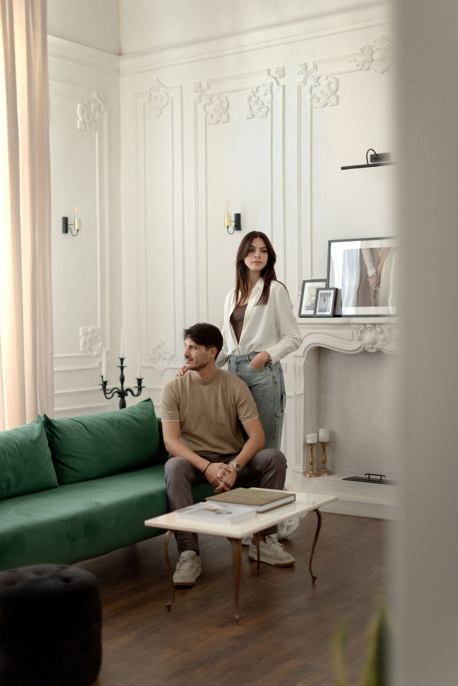 A sequence of photos showing someone lounging on a green couch in a bright white modern living room interior.
