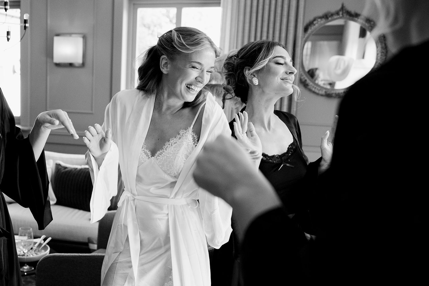 A black and white photo collage showing a bride and groom sharing intimate moments during their wedding celebration.