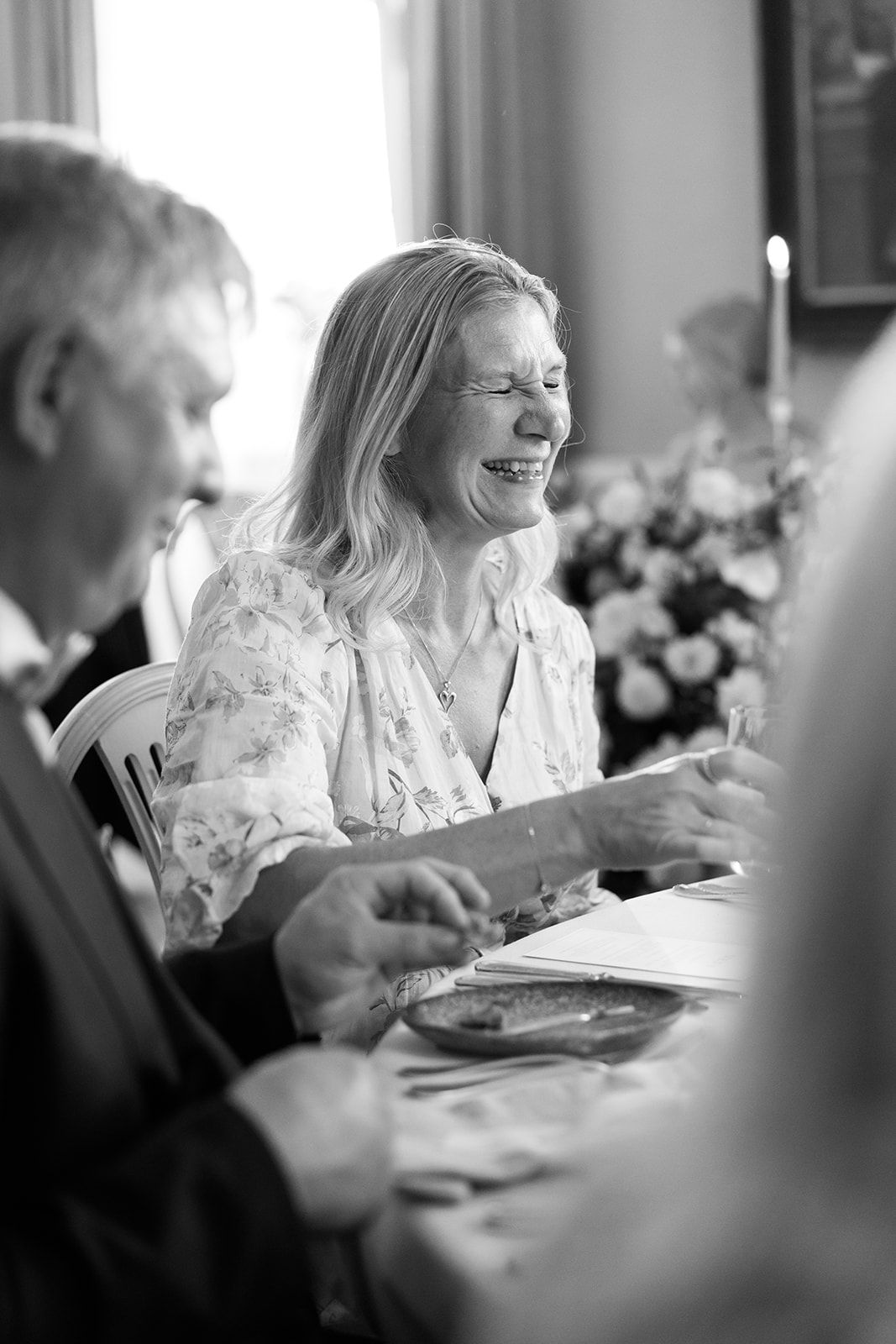 A black and white photo sequence shows joyful moments during a wedding reception dinner.