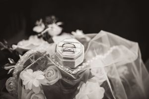 Black and White Flay Lay of Rings, Bouquet, & Veil taken in Blacksburg, Va.