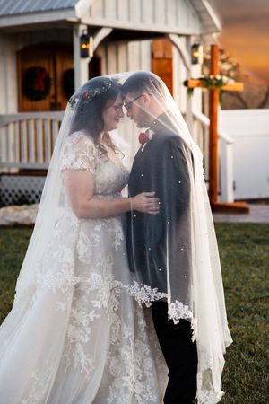 Bride & Groom With Veil at Golden Hour Wedding Portrait taken at White Chapel Farm and Venue in Hillsville, VA.