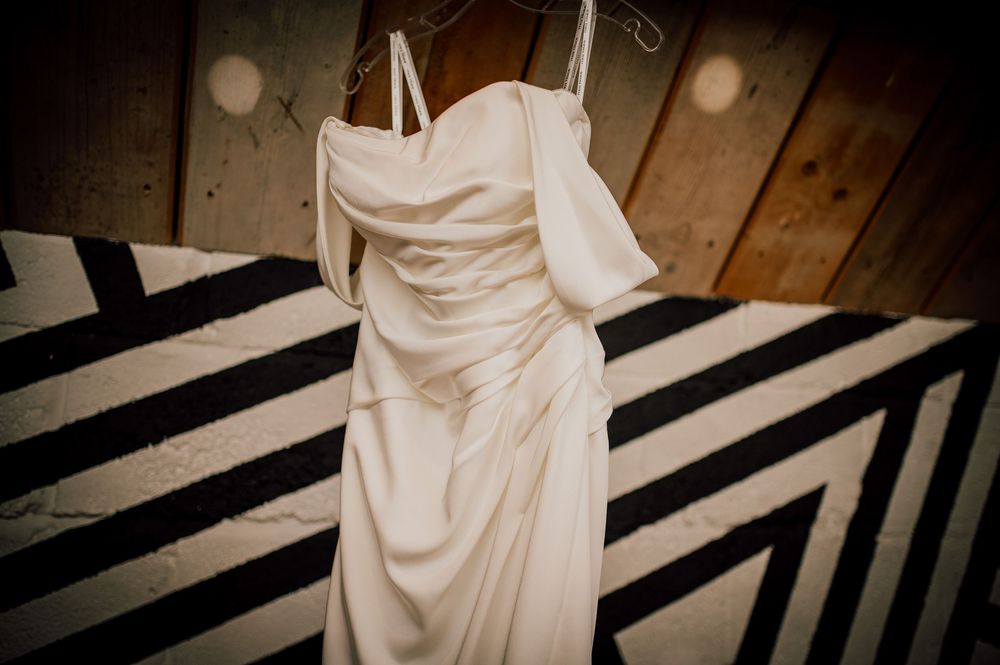 A black and white striped floor pattern with a flowing white wedding dress creating dramatic contrast and elegance.