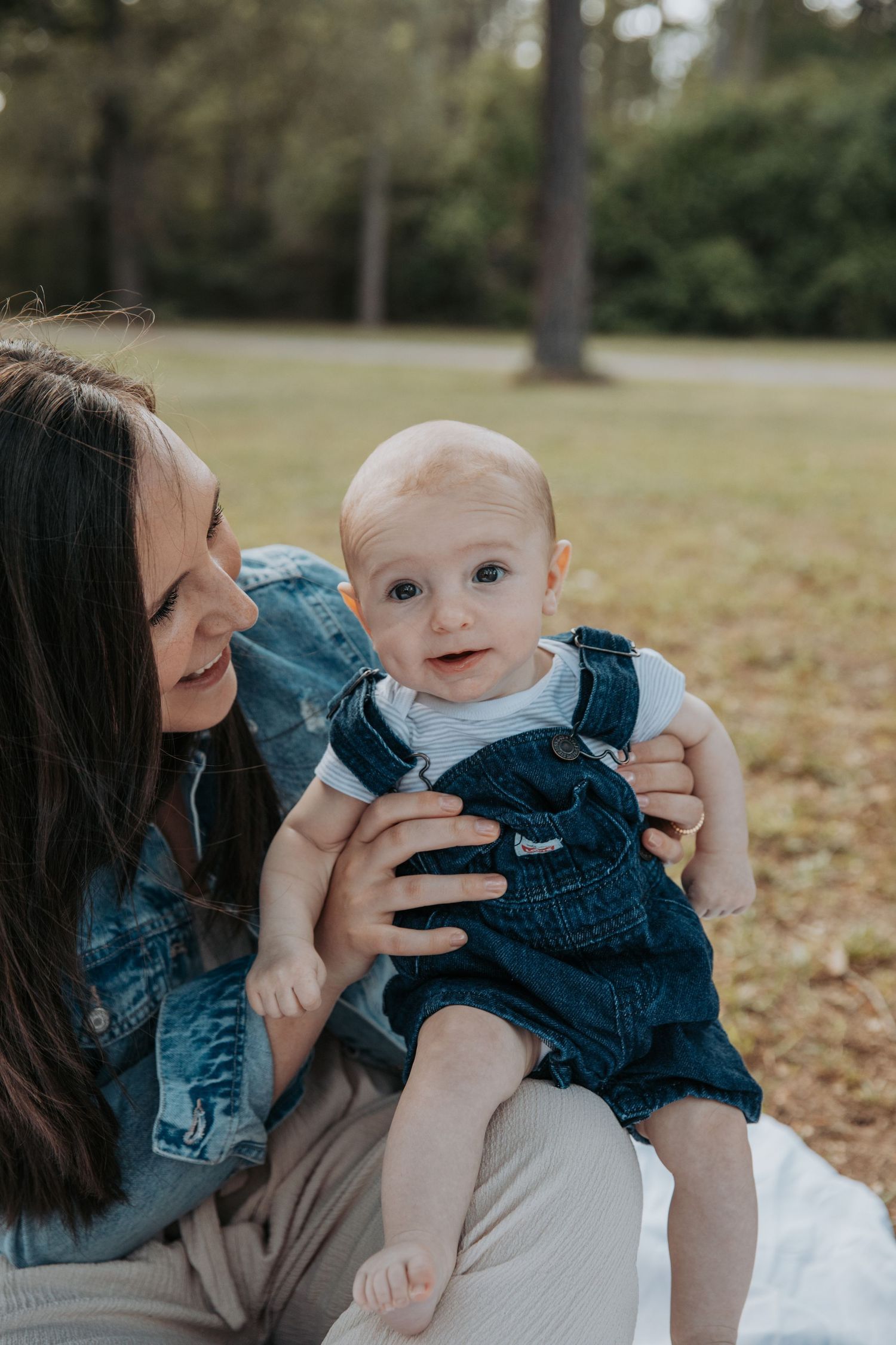 mother holding baby outside photo