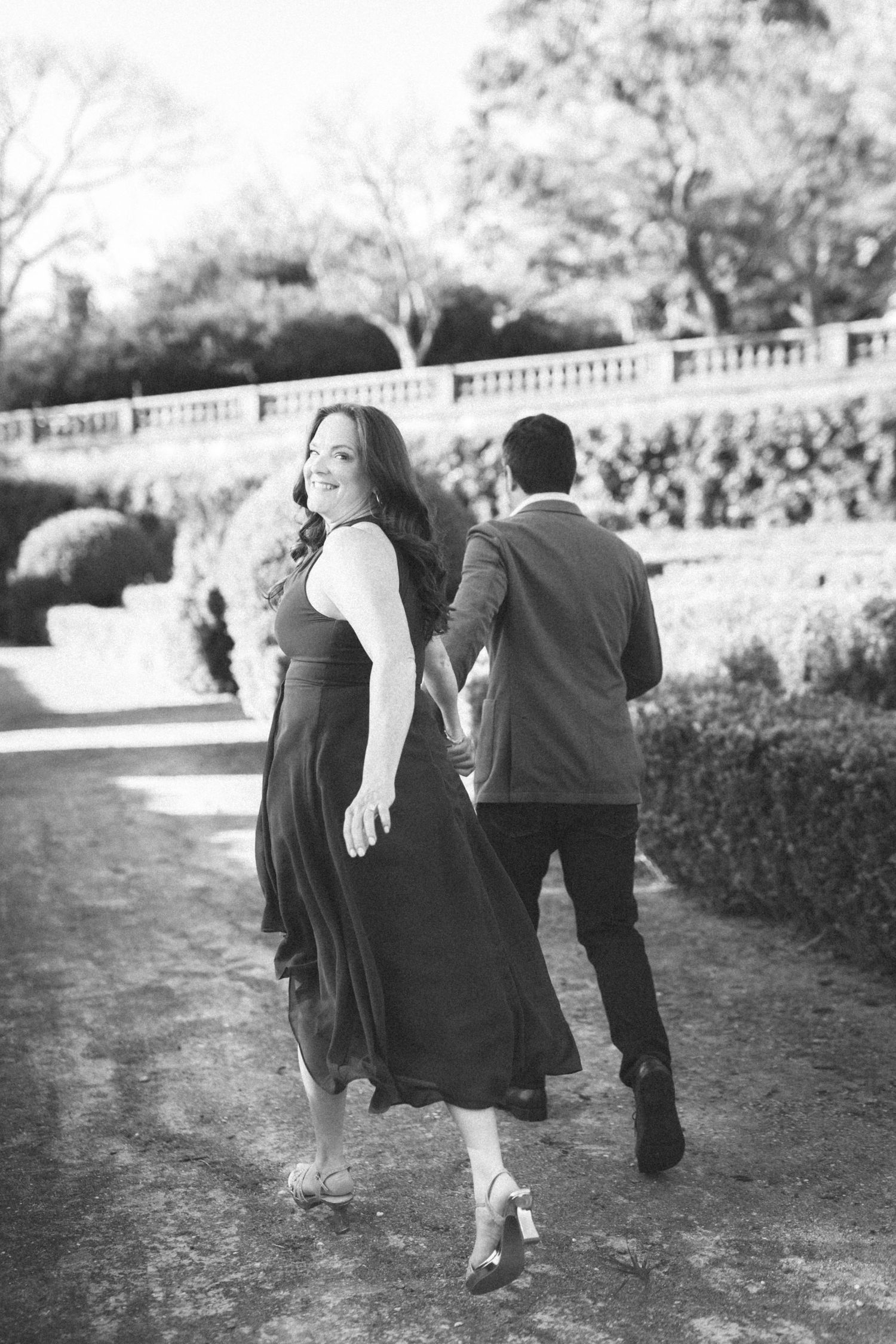 Couple walking through botanical garden Lisbon engagement session
