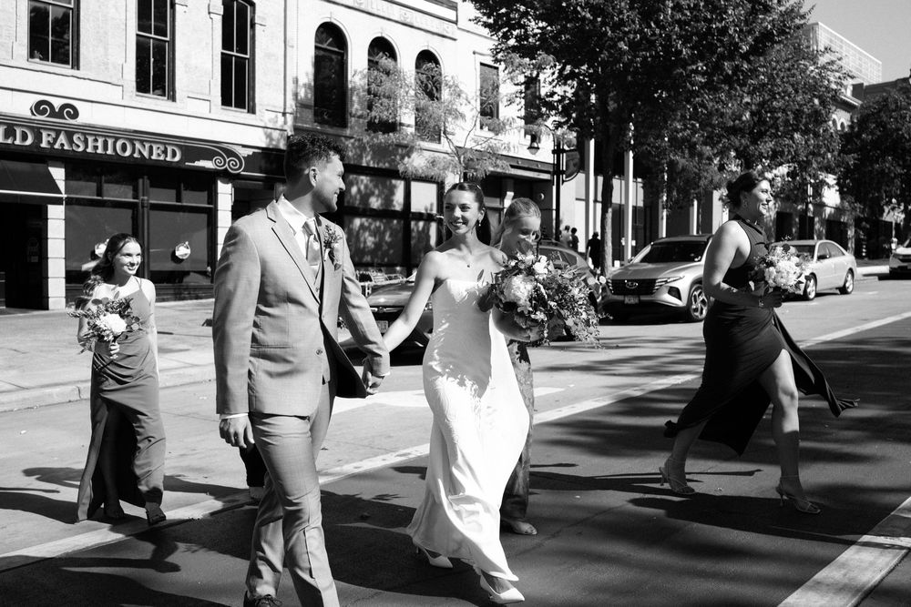 A black and white photo sequence shows a couple walking down a sunny city sidewalk past storefronts.