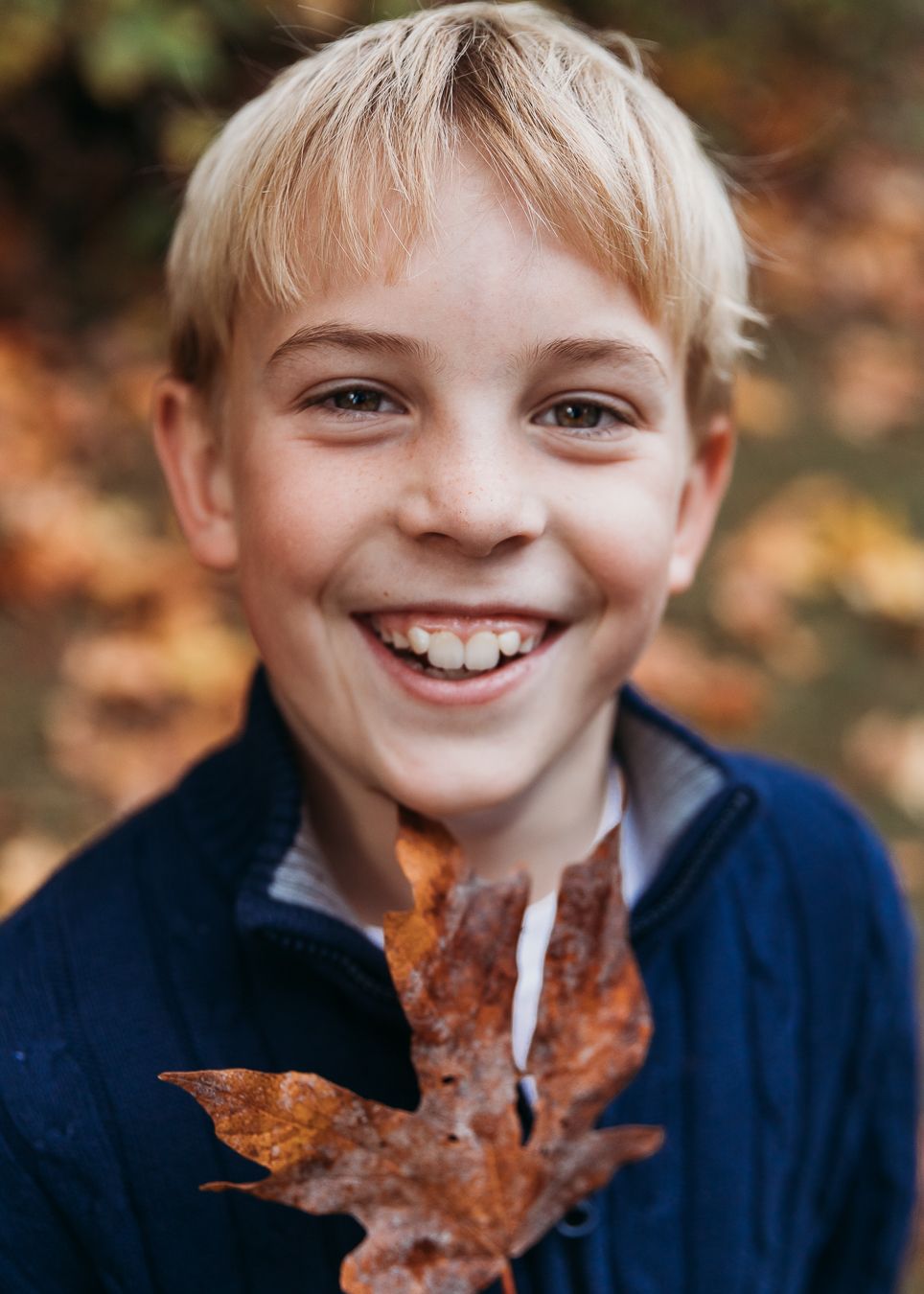 A sequence of five autumn photos showing someone holding a brown maple leaf in front of their face with joyful expressions.