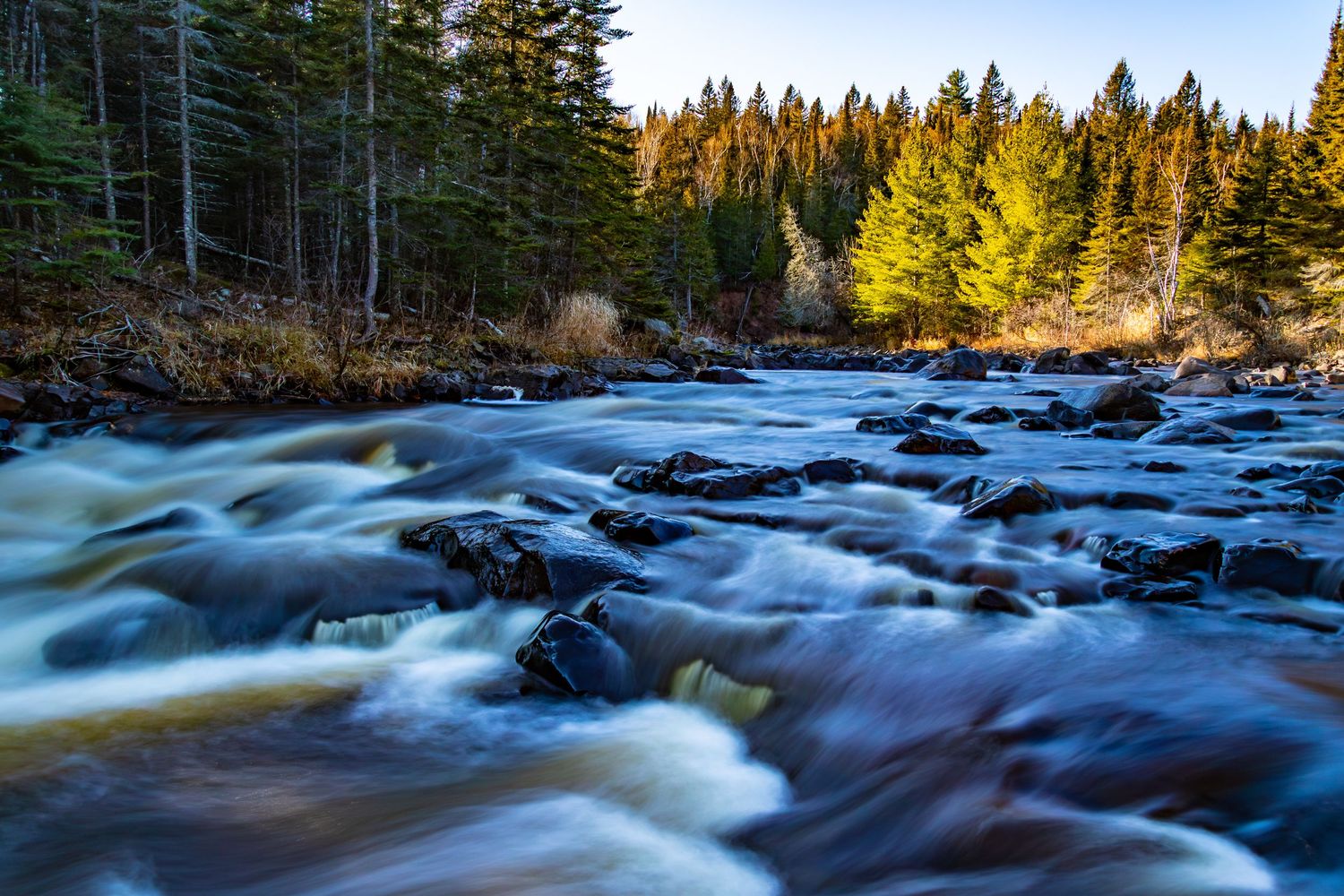 Long exposure fall waterfall landscape photography showing cascading water over mossy rocks on North Shore of MN , calming nature wall art.