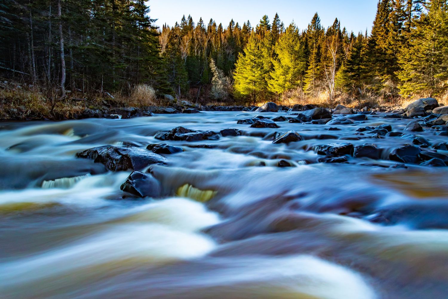 Long exposure fall waterfall landscape photography showing cascading water over mossy rocks on North Shore of MN , calming nature wall art.