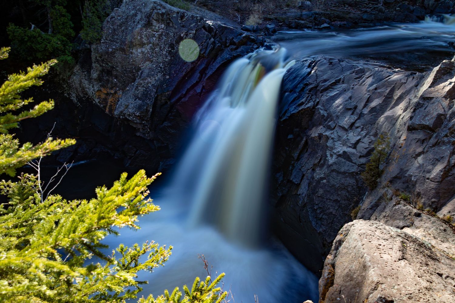 Long exposure fall waterfall landscape photography showing cascading water over mossy rocks on North Shore of MN , calming nature wall art.