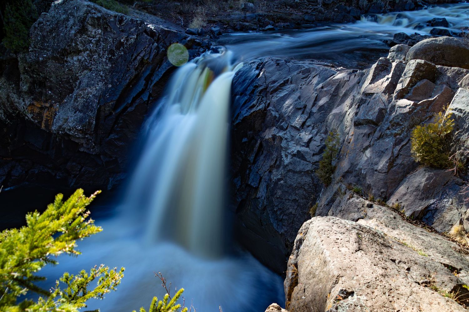 Long exposure fall waterfall landscape photography showing cascading water over mossy rocks on North Shore of MN , calming nature wall art.