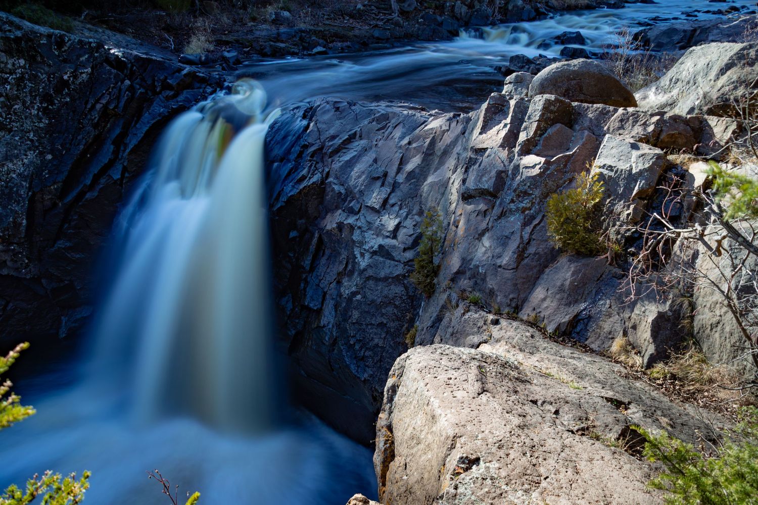 Long exposure fall waterfall landscape photography showing cascading water over mossy rocks on North Shore of MN , calming nature wall art.