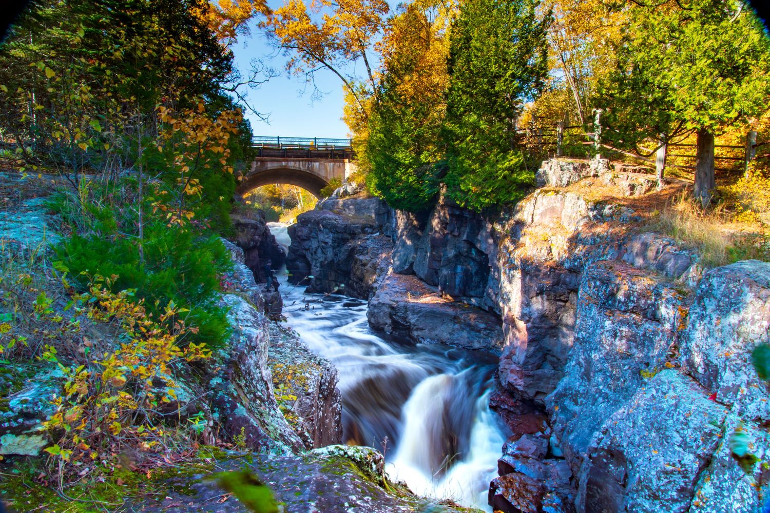 Long exposure fall waterfall landscape photography showing cascading water over mossy rocks on North Shore of MN , calming nature wall art.