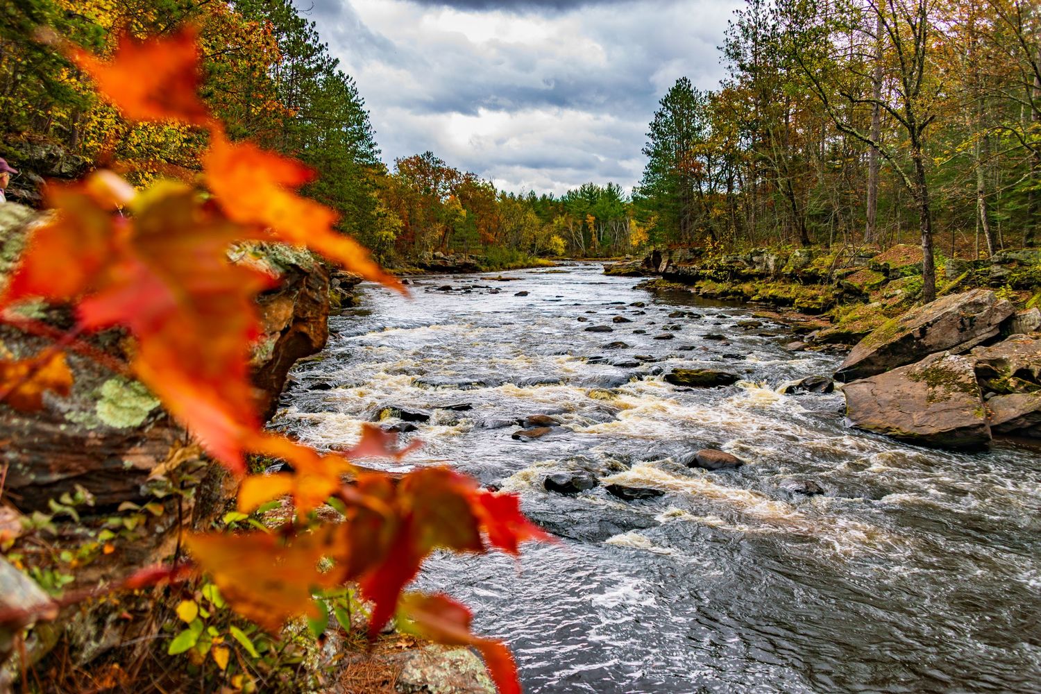 Long exposure fall waterfall landscape photography showing cascading water over mossy rocks in forest of Minnesota, calming nature wall art.