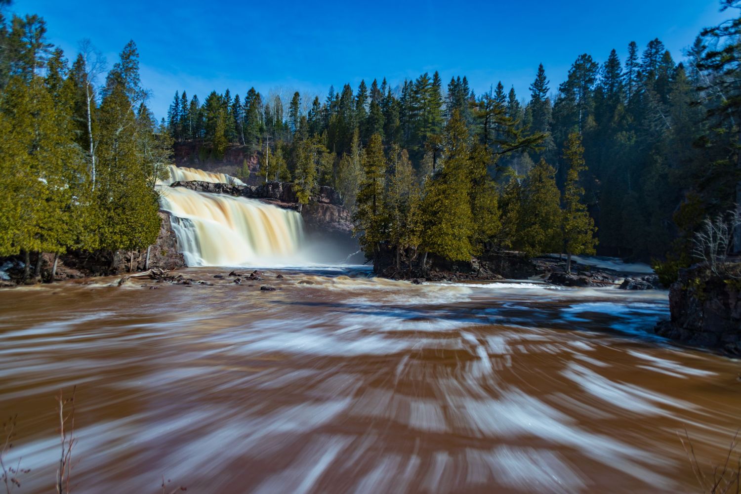 Long exposure fall waterfall landscape photography showing cascading waterfall of Gooseberry Falls State Park MN, calming nature wall art.