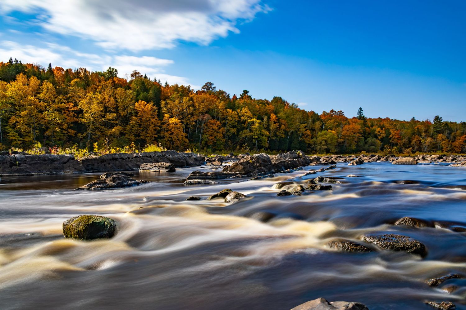 Long exposure fall waterfall landscape photography showing cascading water over mossy rocks in forests of Jay Cook, calming nature wall art.