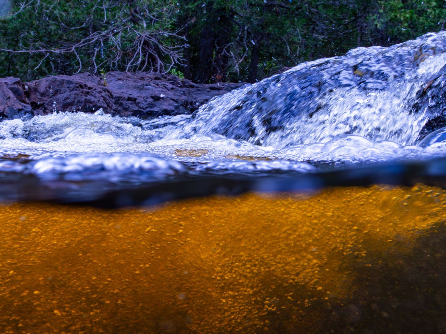 Long exposure underwater landscape photography showing split above and below river in Minnesota, calming nature wall art.