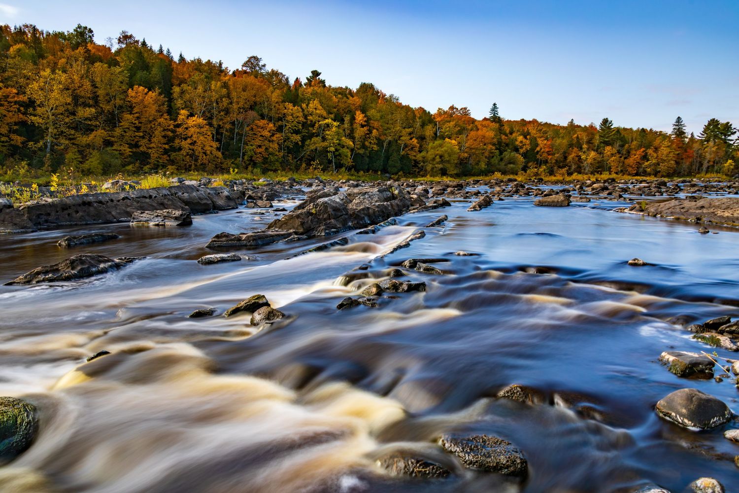 Long exposure fall waterfall landscape photography showing cascading water over mossy rocks in forests of Jay Cook, calming nature wall art.