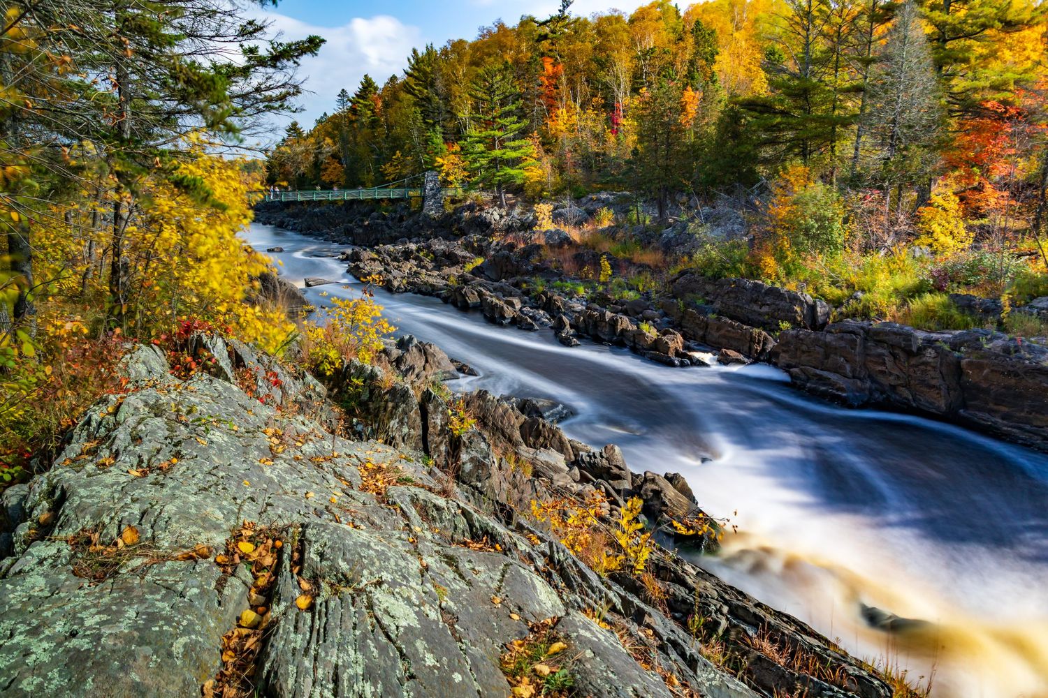 Long exposure fall waterfall landscape photography showing cascading water over mossy rocks in forests of Jay Cook, calming nature wall art.